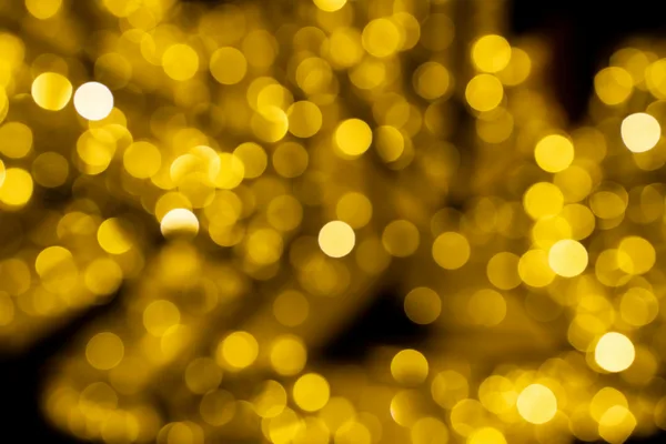 Sfondo bokeh dorato astratto con luci festive e sfocate