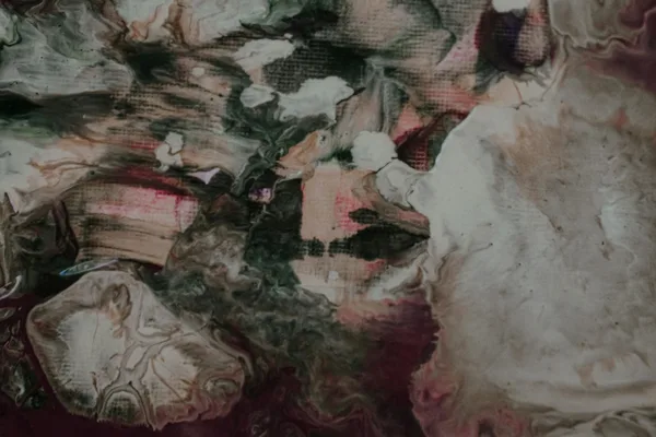 From above of abstract background representing smears with various color tones and blots with fluids