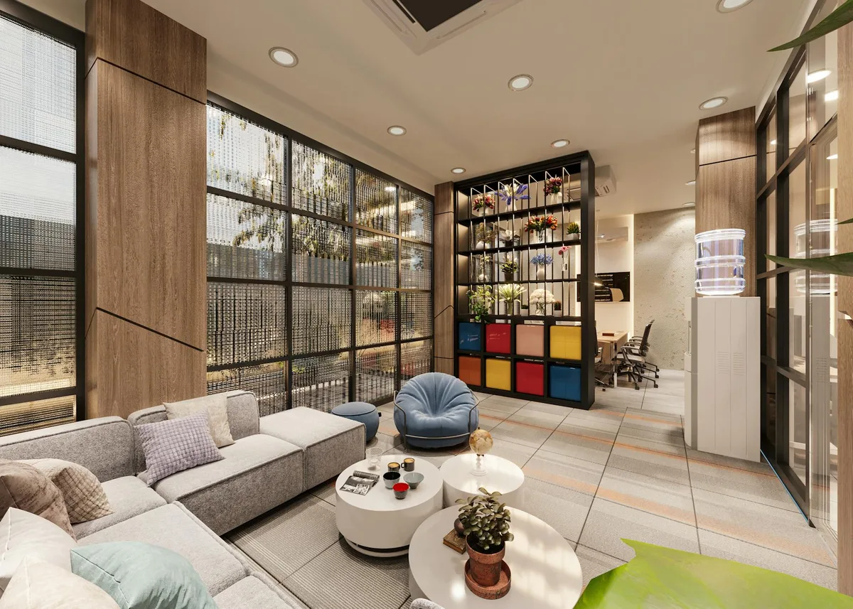 Salon de bureau cosy avec mobilier moderne, grandes fenêtres et décoration vibrante.