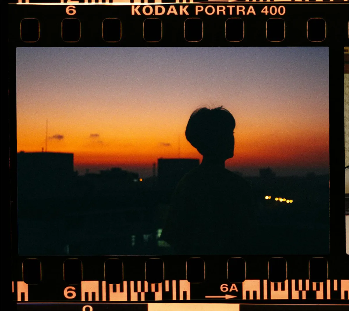 Sagoma di una persona contro un tramonto vibrante su pellicola Kodak Portra 400