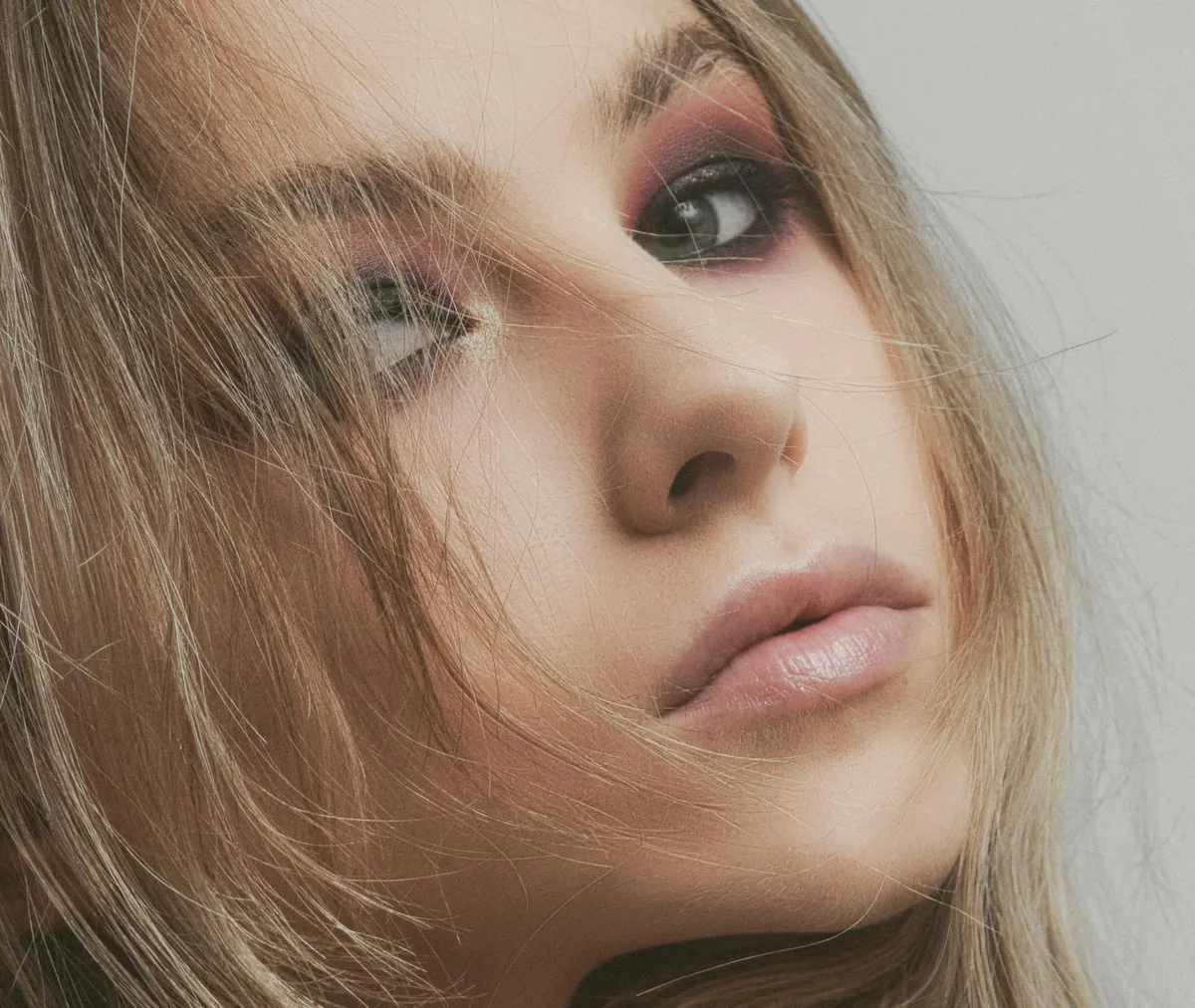 Portrait en gros plan d'une femme au maquillage artistique sublimant sa beauté naturelle