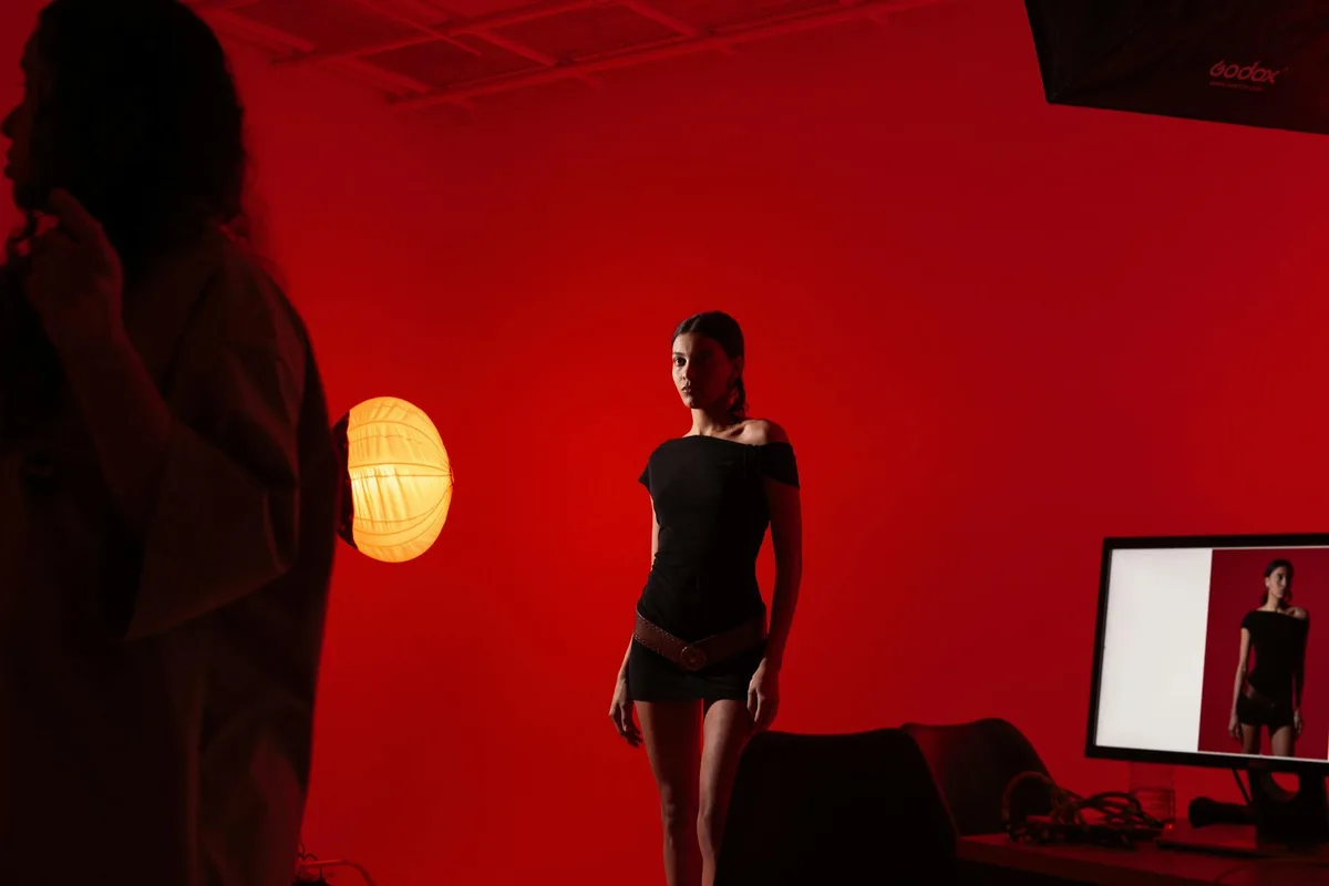 Элегантная модель в красном свете для креативной фотосессии в студии