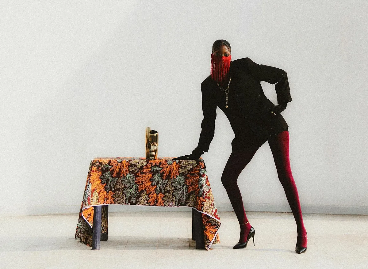 Modelo estilosa posando com padrões têxteis vibrantes em estúdio