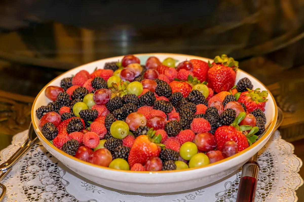 A colorful assortment of fresh berries and grapes in a bowl, highlighting nutritious fruits.