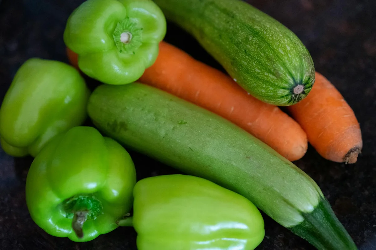 Colorful assortment of fresh vegetables including bell peppers, zucchinis, and carrots.