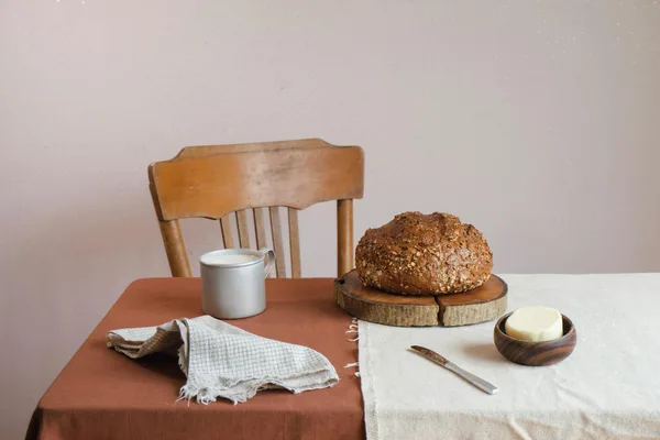 Rustic table setting featuring fresh bread and butter with a vintage charm, perfect for cozy mornings.