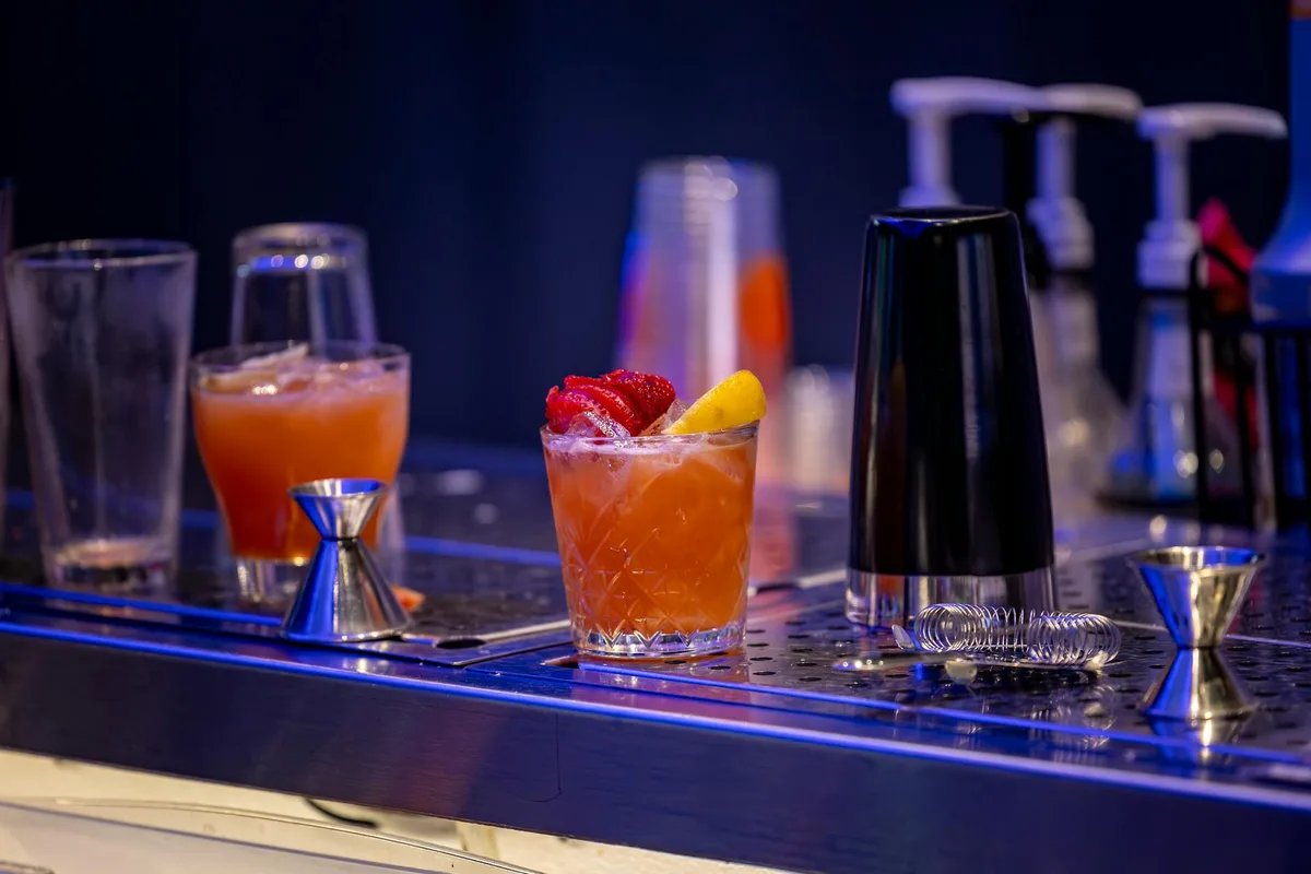 Cocktail vibrante con guarnizione su bancone elegante per scene notturne