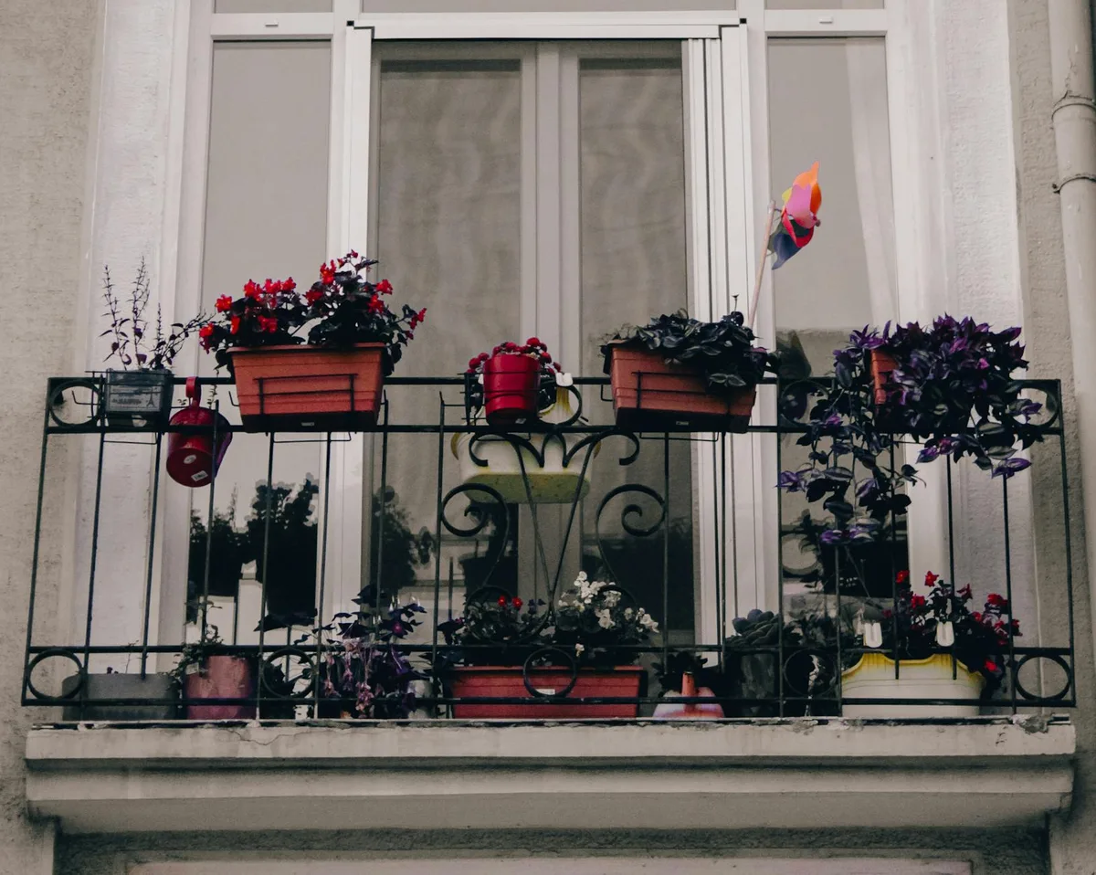 A picturesque balcony in Istanbul adorned with colorful potted plants, adding a touch of nature.