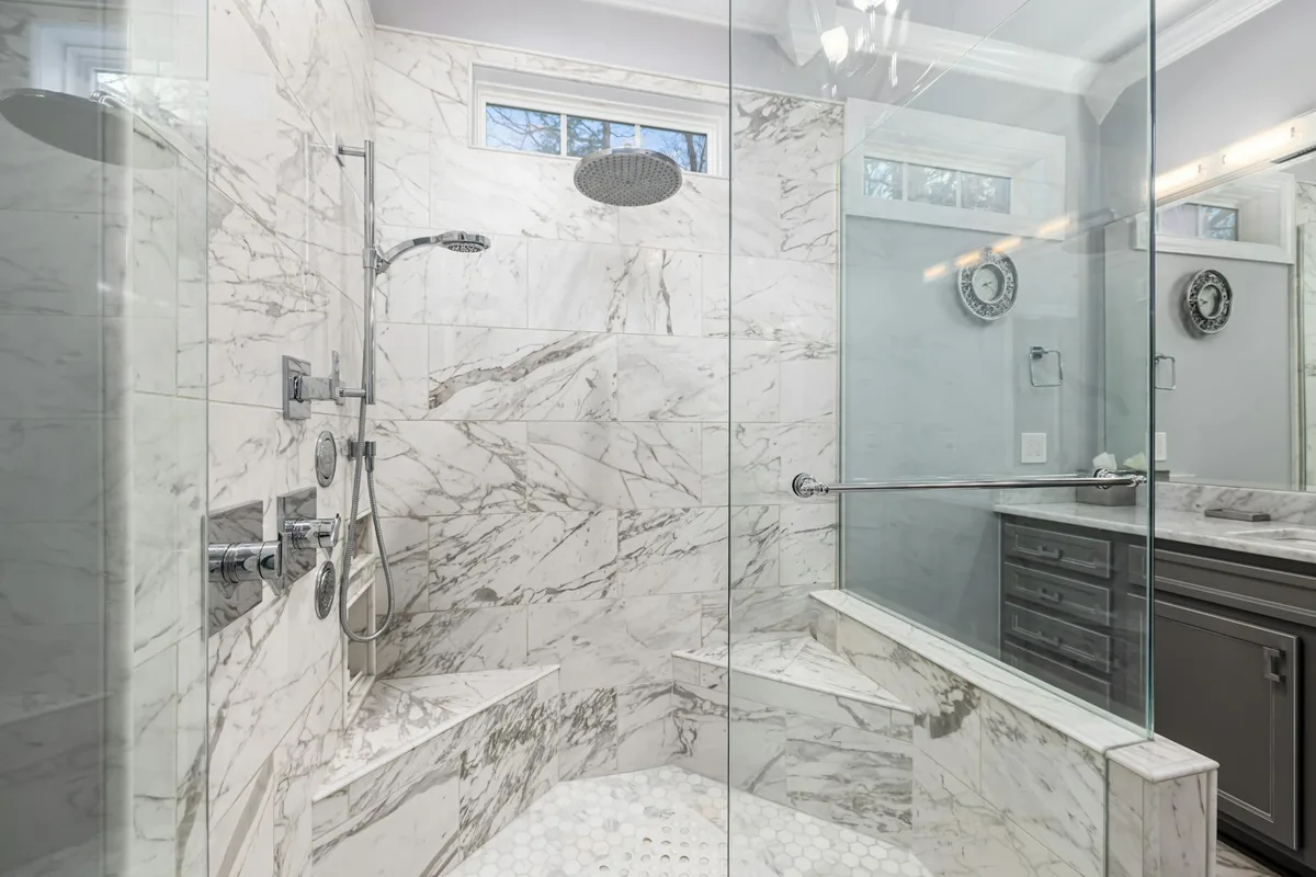 Elegant marble bathroom with contemporary design and glass shower.