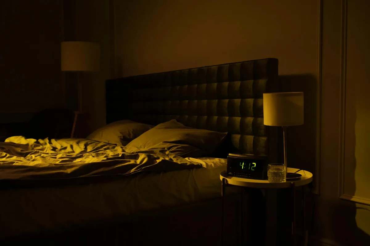 Entspannendes, schwach beleuchtetes Schlafzimmer mit Digitaluhr und warmem Umgebungslicht