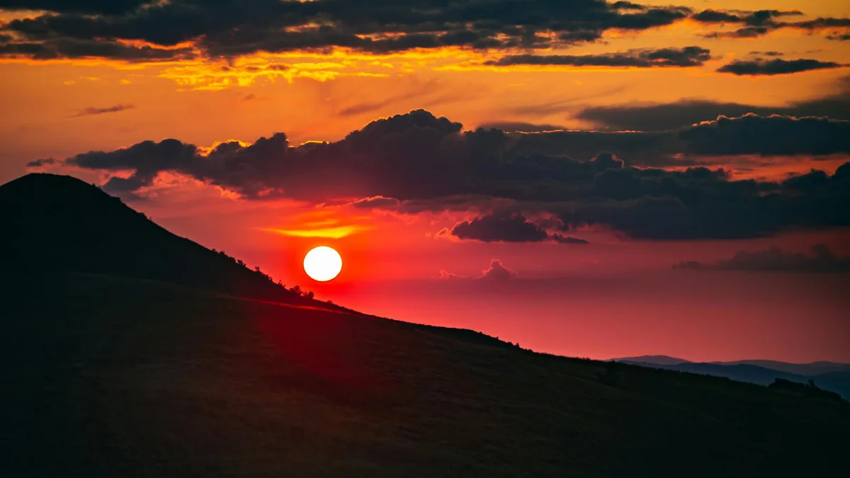 Sonnenuntergang über den Hügeln in Podkarpackie, Polen, mit dramatischen Wolken