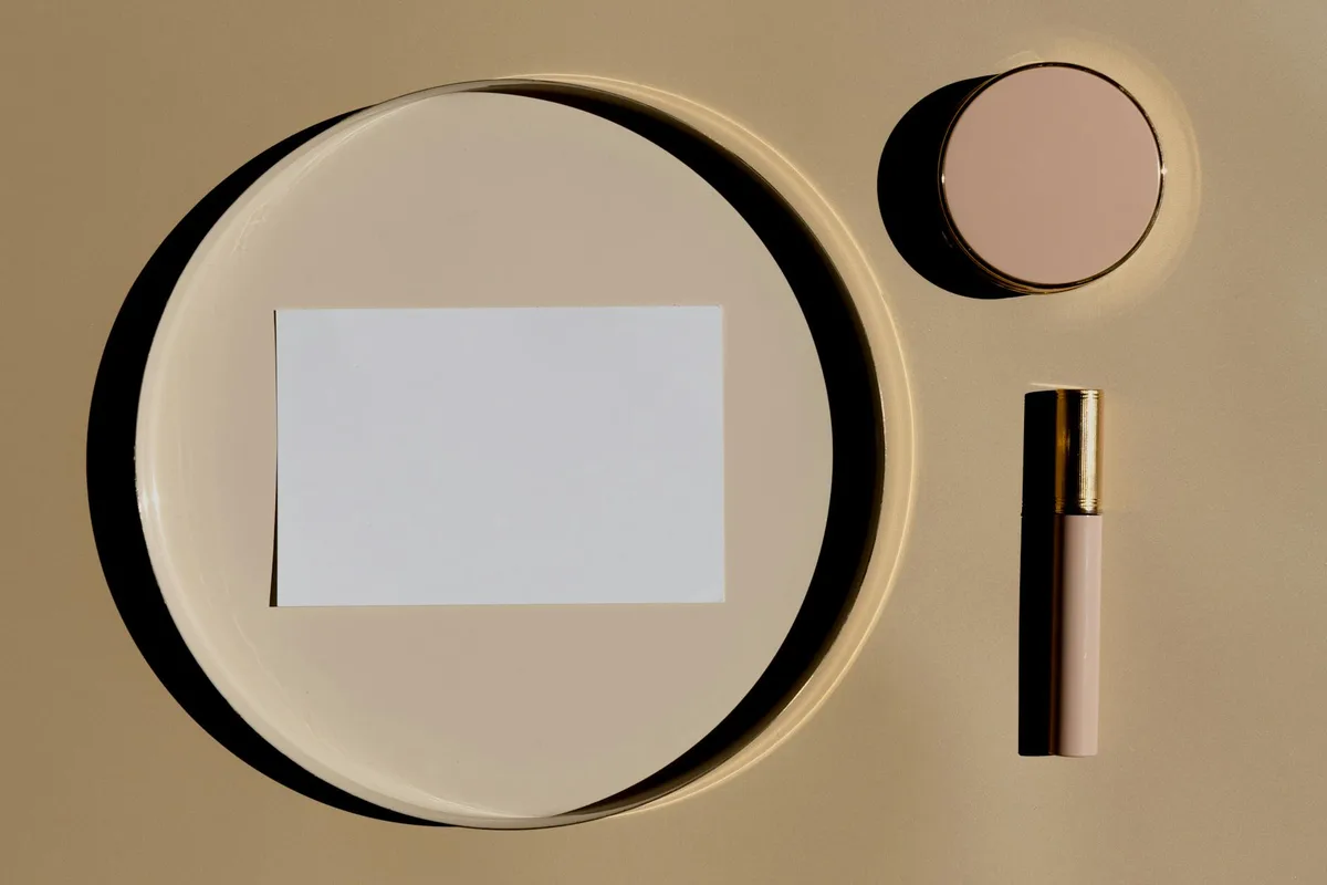 Essentials per make-up su fondo beige nude vista dall'alto