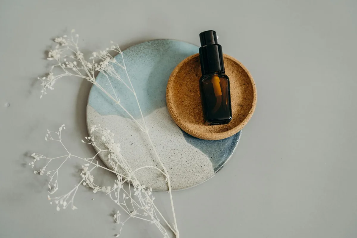 Flatlay cosmetico su piatti in ceramica con fiori secchi