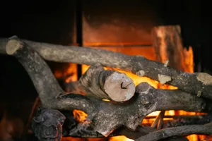 Warm and inviting close-up of firewood in a glowing fireplace, perfect for winter ambiance.