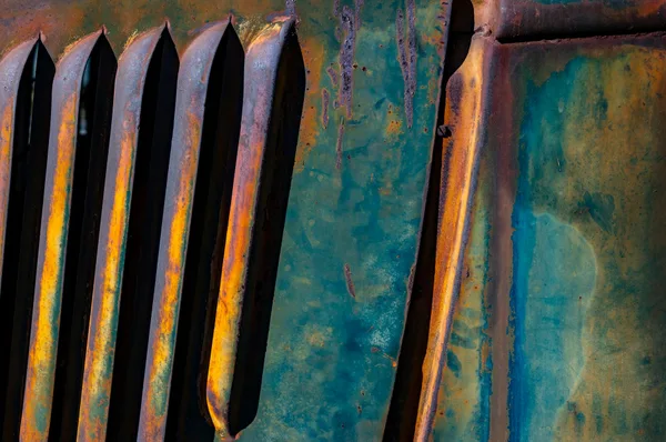 Close-up of rusted metal with vibrant patina, showcasing unique texture and color.