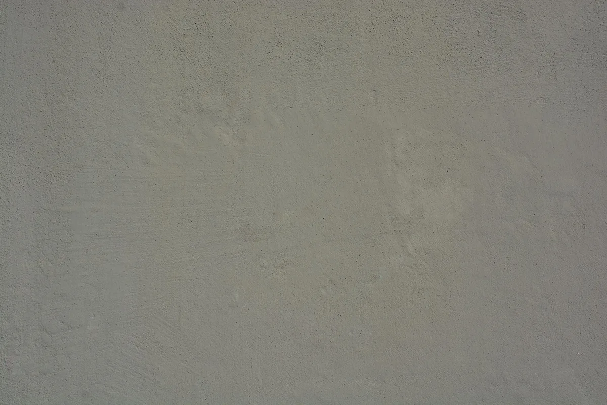 Imagem de alta resolução de parede de concreto cinza com textura áspera e desgaste natural