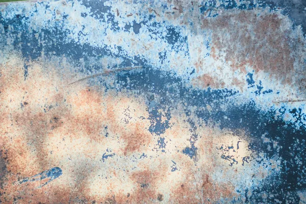 Texture of a weathered and rusted metal surface with abstract patterns.