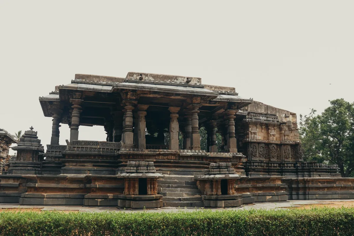 A historic stone temple featuring intricate carvings and pillars, showcasing traditional architecture.