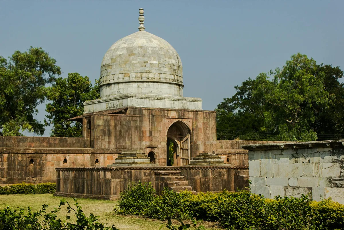 Hoshang Shah's Tomb, a historic mausoleum in Mandu, India, surrounded by lush greenery.