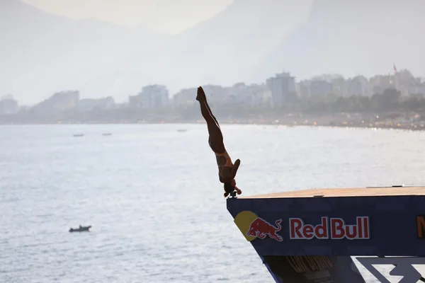 Professional diver mid-air dive during competition in Antalya, Türkiye, showcasing athletic prowess.