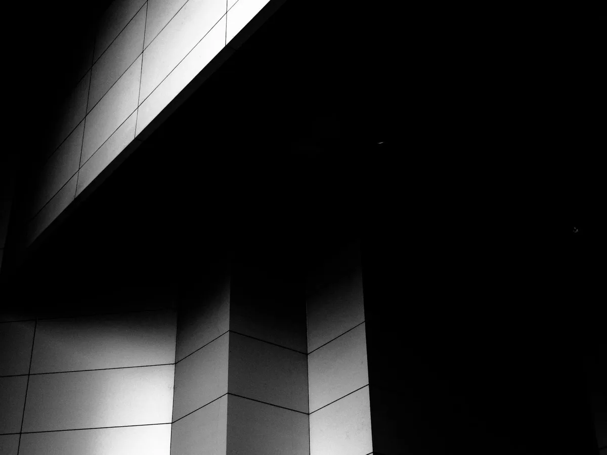 A dramatic black and white view of modern architectural lines and angles.