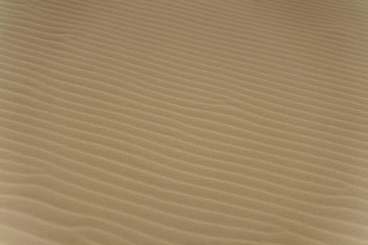 Primo piano di sabbia ondulata nel deserto, texture naturali in evidenza