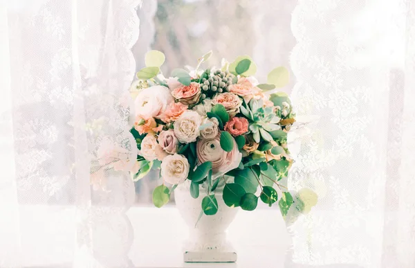 A beautiful bouquet of pastel flowers in a vase, perfect for elegant home decor.