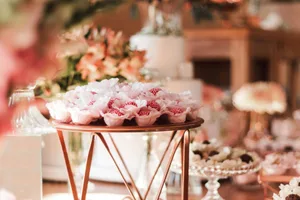 Close-up of beautifully arranged decorative treats on a wedding dessert table in pastel colors.
